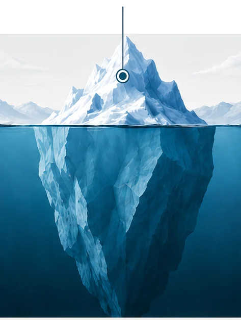 An iceberg standing tall above the waterline, its bright peak in full view.